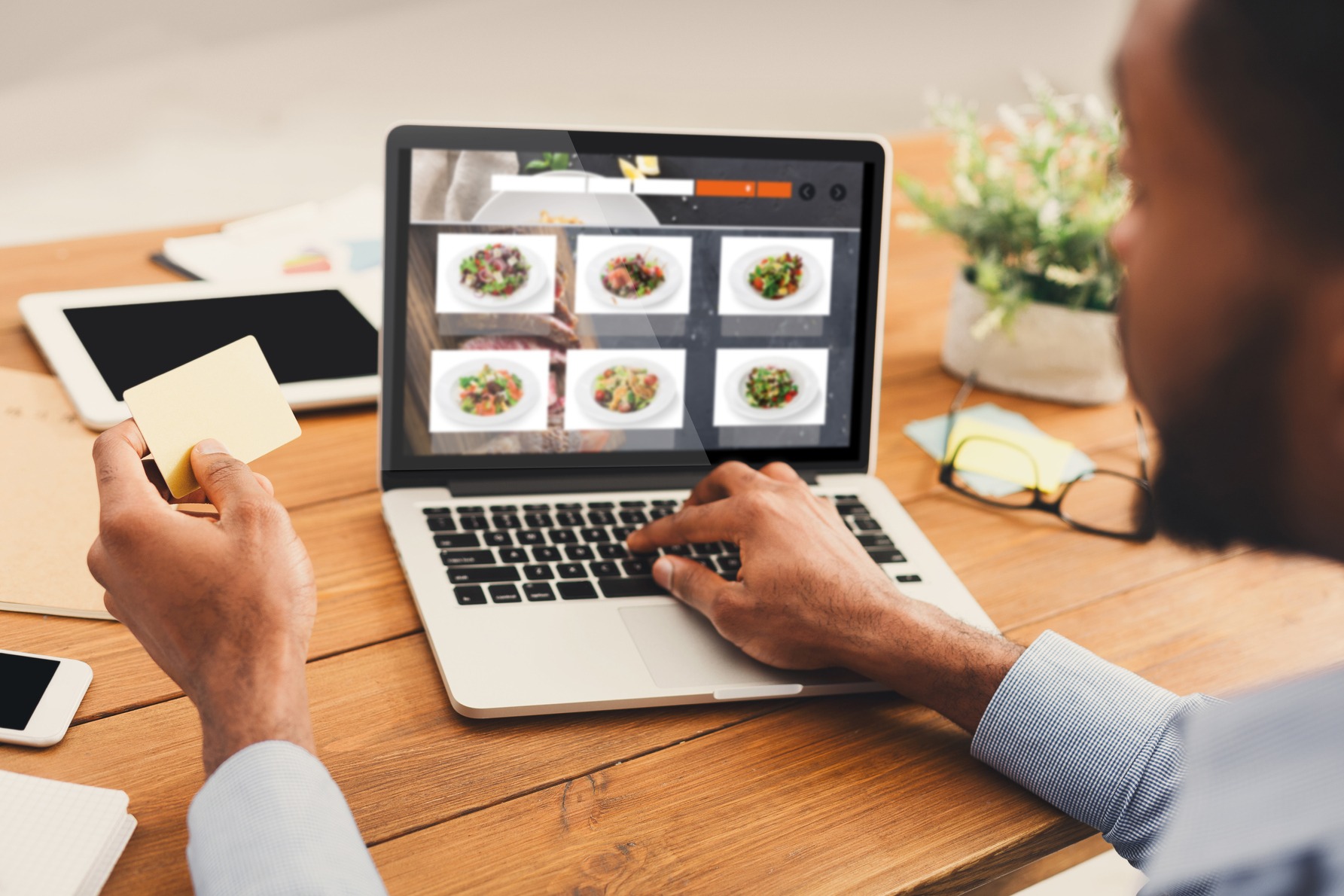 african-businessman-ordering-lunch-online-on-lapto-2023-11-27-05-20-52-utc